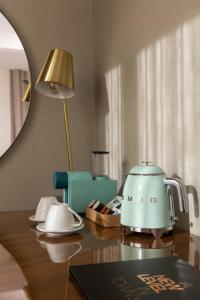 a table with a tea kettle on top of it at Next Level Premium Hotels in Lisbon