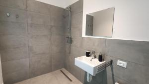 y baño con lavabo y espejo. en Bed & Bike Hostel en San Giovanni in Persiceto