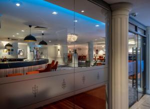 a view of a lobby with a bar and chairs at Copthorne Aberdeen Hotel in Aberdeen