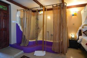 a bathroom with a shower in a room at Jafferji House in Zanzibar City