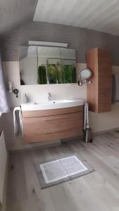 a bathroom with a sink and a mirror at Ferienwohnung Sommerfeld in Bispingen