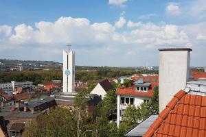 a church with a cross on the side of a building at 5 Secret escape apartment above Stuttgart in Stuttgart