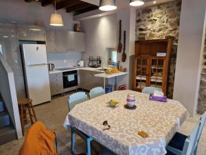 a kitchen with a table and chairs and a kitchen with a counter at Filia Country House in Fília