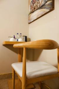 a wooden table and a chair in a room at Milestone Hotels in Lusaka