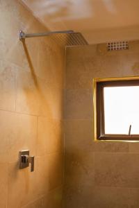 a bathroom with a shower with a window at Milestone Hotels in Lusaka