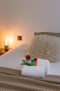 een bed met handdoeken en een bloem erop bij Quick - Charming double room at ranch "De Blauwe Zaal" in Brugge