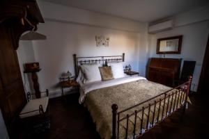 ein Schlafzimmer mit einem großen Bett mit weißen Kissen in der Unterkunft Domeniul Drăgași 
