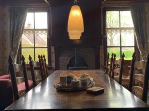 a dining room with a table and a fireplace at De Middelste Dam in Mildam