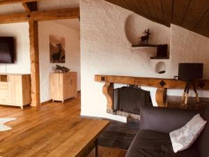 - un salon avec une cheminée et un canapé dans l'établissement Ferienwohnung Tanneberger, à Oberstdorf
