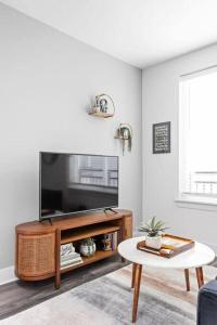 a living room with a television and a coffee table at Mid-Century Modern Studio CozySuites Downtown in Indianapolis