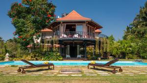 a house with a swimming pool in front of a house at amã Stays & Trails Skyfall , Kashid in Kashid