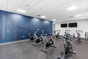 a gym with a bunch of exercise bikes in a room at Dream Apartment near Whole Foods CozySuites in Indianapolis