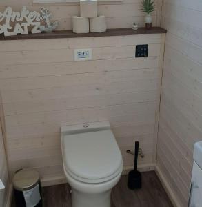 a small bathroom with a white toilet in a room at Knobis-DREAM-PLACE in Fehmarnsund