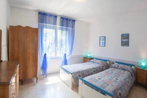 a bedroom with two beds and a window at Casa Legnone in Piantedo