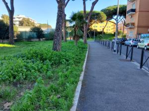 a sidewalk next to a street with parked cars at Annadia Sweet Home B&B in Lido di Ostia