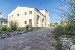 a house with a stone driveway in front of it at Residence Superstar in San Martino di Lupari