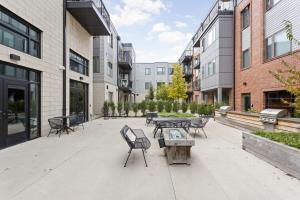 a courtyard with tables and chairs and buildings at CozySuites Modern Studio steps from Broad Ripple in Indianapolis