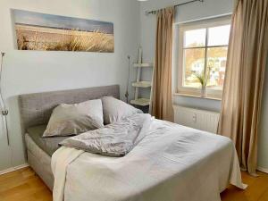 a bedroom with a bed and a window at discovAIR Graal-Müritz -Villa Victoria- Strandnah mit Netflix in Graal-Müritz