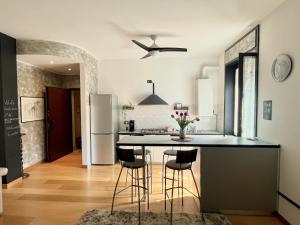a kitchen with a black counter and a refrigerator at Appartamento Dante in Seregno