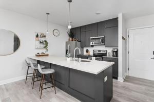 a kitchen with black cabinets and a white counter top at Spacious 2BR in Meridian Kessler by CozySuites in Indianapolis