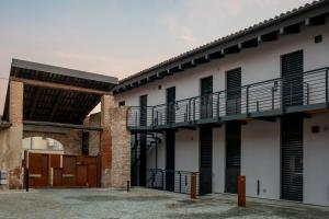 an external view of a building with a balcony at SERENDIPITY apartments in Alba