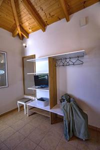 Habitación con estante y TV en una habitación en Forti Retreat Georgia en Kariotes