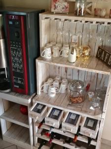 a shelf with a coffee maker and other items on it at Gästehaus Nord-West 1700 - Doppelzimmer Ozean in Steenfeld