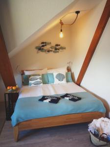 a bedroom with a bed with blue sheets at Gästehaus Nord-West 1700 - Doppelzimmer Ozean in Steenfeld