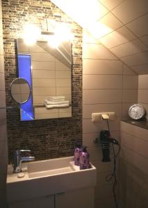 La salle de bains est pourvue d'un lavabo et d'un miroir. dans l'établissement Gästehaus Nord-West 1700 - Doppelzimmer Beach, à Steenfeld