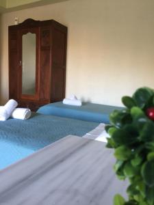 a room with two beds with a mirror at happyWish Syros in Ermoupoli