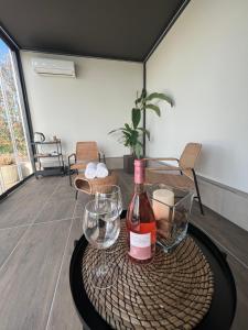 uma garrafa de vinho e um copo sobre uma mesa em Agriturismo Colle Dei Pivi em Ponti Sul Mincio