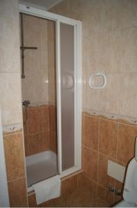 a shower with a glass door in a bathroom at Vila Slatine - Beach Apartments in Slatine