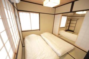 Tempat tidur dalam kamar di Rakuzen Nijo