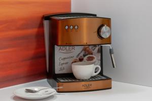 a coffee maker with a cup of coffee at Apartment MiAMar in Rogowo with Furnished Terrace and Parking by Renters in Rogowo