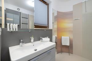 a bathroom with a white sink and a mirror at Apartment MiAMar in Rogowo with Furnished Terrace and Parking by Renters in Rogowo