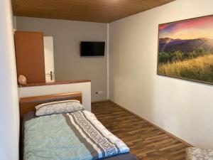 ein Schlafzimmer mit einem Bett und einem Wandgemälde in der Unterkunft Schulungszentrum Töplitz in Leest