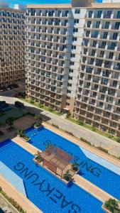 an overhead view of a swimming pool with two large buildings at Saekyung Condominium in Lapu Lapu City