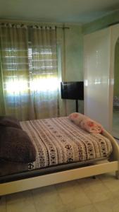 a bed in a room with a window with a curtain at casa vacanza trastevere in Rome