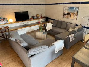 a living room with two couches and a flat screen tv at Ferienwohnung Thiel in Neumark