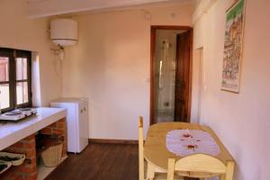 a kitchen with a table and a chair in a room at One bedroom house with wifi at Antananarivo in Antananarivo