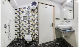 a bathroom with a toilet and a sink and a mirror at FabHotel Prime Orion Crystal in Kolkata