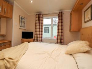 a bedroom with a large bed and a window at Larenzo in Preston