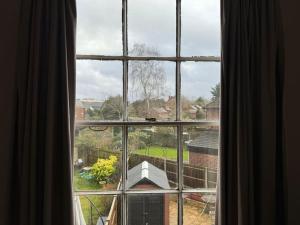 a window with a view of a yard at The“LITTLE BOLT”In Reading. in Earley