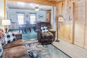 a living room with a couch and a table at 4 BDRM - Hot Tub - Fire Pit in Old Forge