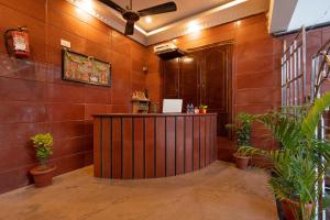 un vestíbulo con un bar de madera en una sala con plantas en Hotel Arya Grand Rameswaram by Nimalan, en Rameswaram