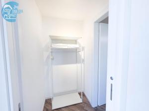 a white closet with a glass shelf in a room at Basovizza 3 Chanel Tirabora Short Rent in Villa Opicina