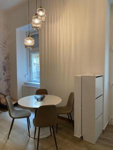 a dining room with a white table and chairs at Dembinszky utca in Budapest