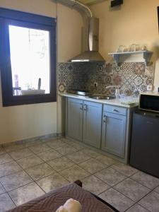 a kitchen with a sink and a window at happyWish Syros in Ermoupoli