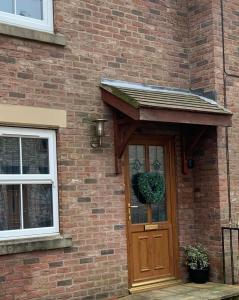 an awning over the door of a brick house at Ouse House in Swinefleet