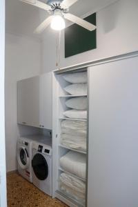 a laundry room with a stack of towels and a washing machine at Magical villa western peloponnese by MPS in Pyrgos